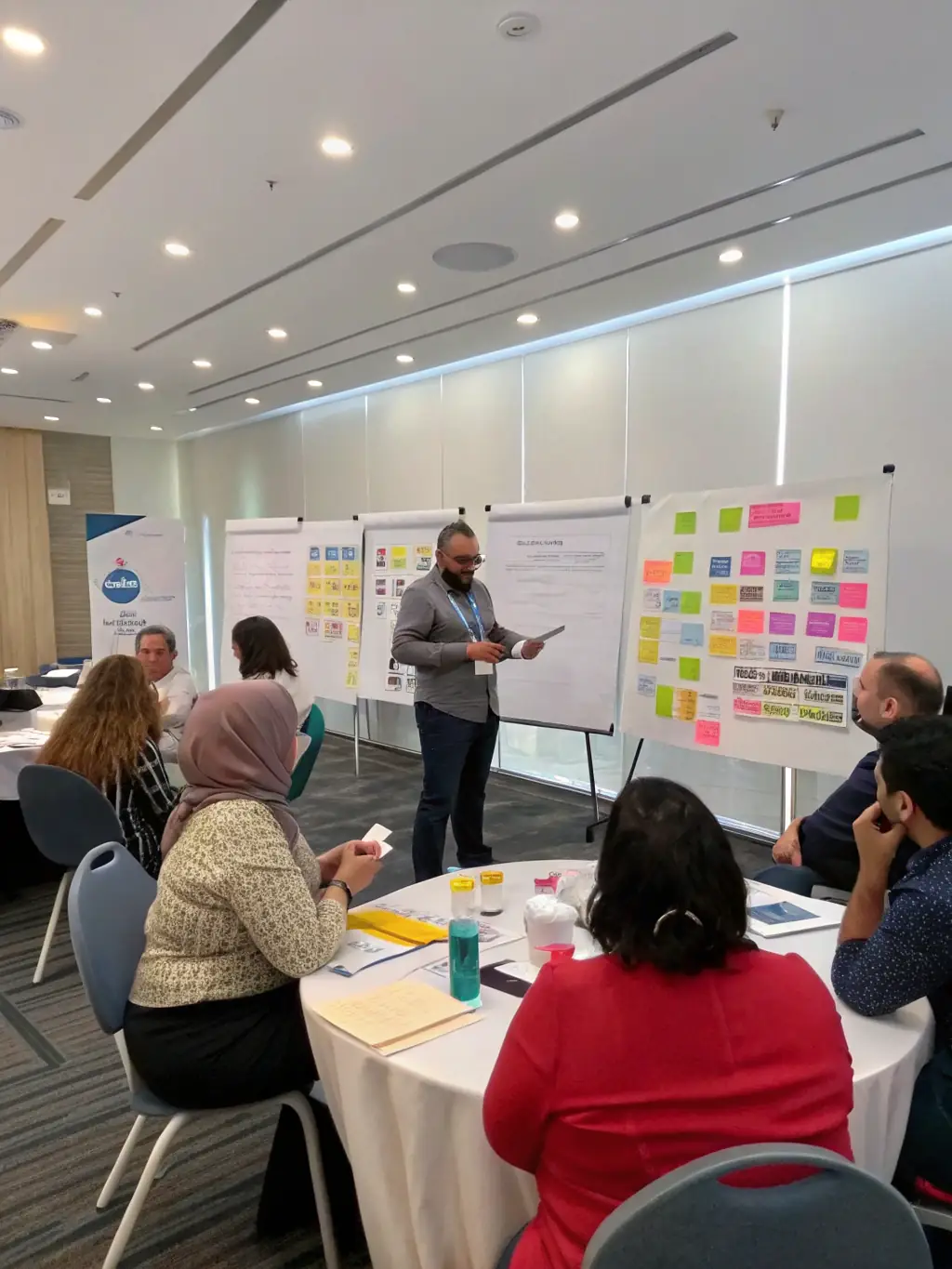 A consultant leading a workshop on change management, with participants actively engaged in discussions and activities.